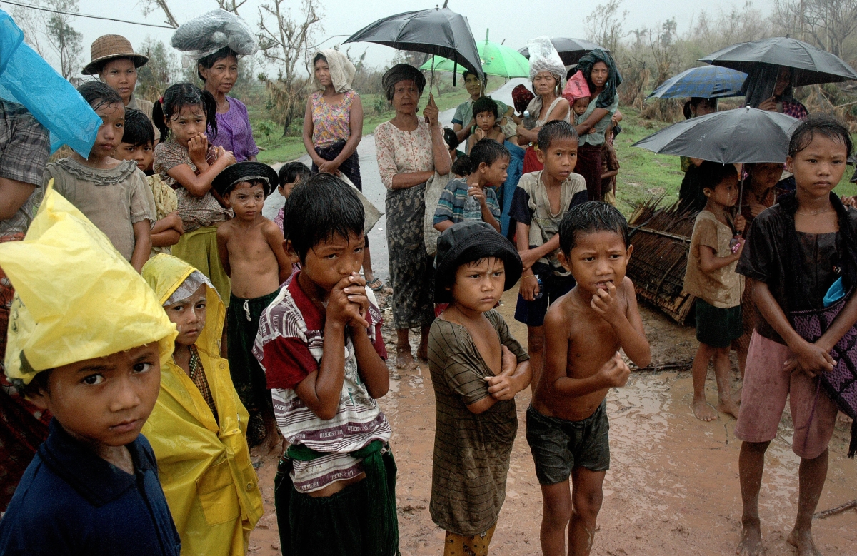 Survivors of the cyclone Nargis wait under the rain to collect relief food in Kyaiklat, in the Ayeyarwady Division of south-west Myanmar [Burma] on May 12, 2008. (Khin Maung Win/AFP/Getty Images)