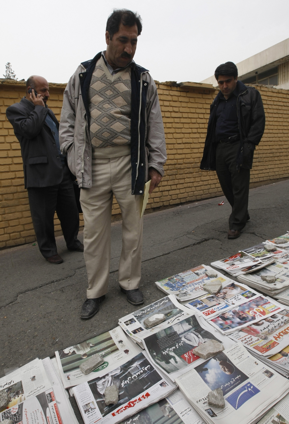 Iranian men look at newspapers bearing news and pictures of US elected president Barack Obama in Tehran on November 5, 2008. (BEHROUZ MEHRI/AFP/Getty Images)