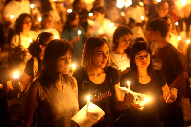 MUMBAI, INDIA - NOVEMBER 30: Mumbai residents walk with candles in the street near The Oberoi Hotel during a demonstration against the recent terror attacks in the city. (Uriel Sinai/Getty Images)
