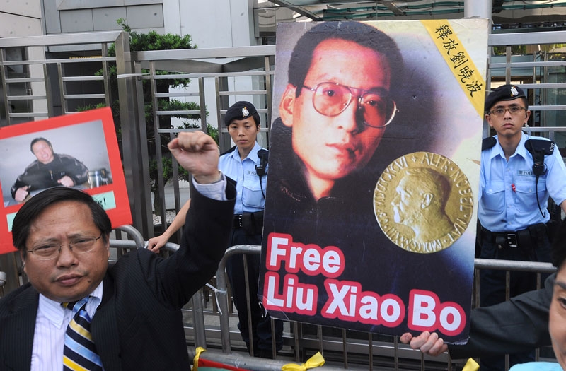 Protesters from Hong Kong's Democratic Party and China Human Rights Lawyers Concern Group demonstrate for the release of jailed Chinese dissident Liu Xiaobao (pictured C) outside the China liaison offices in Hong Kong on October 11, 2010. (Mike Clarke/AFP/Getty Images)