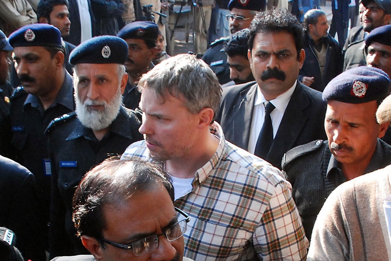 Pakistani police escort arrested US national Raymond Davis (C) to a court in Lahore on Jan. 28, 2011. On Feb. 17 a Pakistan court adjourned until Mar. 14, without ruling whether the CIA employee accused by police of murdering two men qualifies for diplomatic immunity. (Arif Ali/AFP/Getty Images) 
