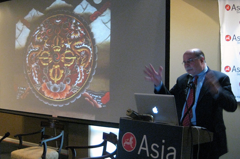 Next to a traditional Bhutanese motif, Dr. Bruce Buntling discusses modern-day Bhutan in Washington on May 5, 2011. (Asia Society Washington Center)