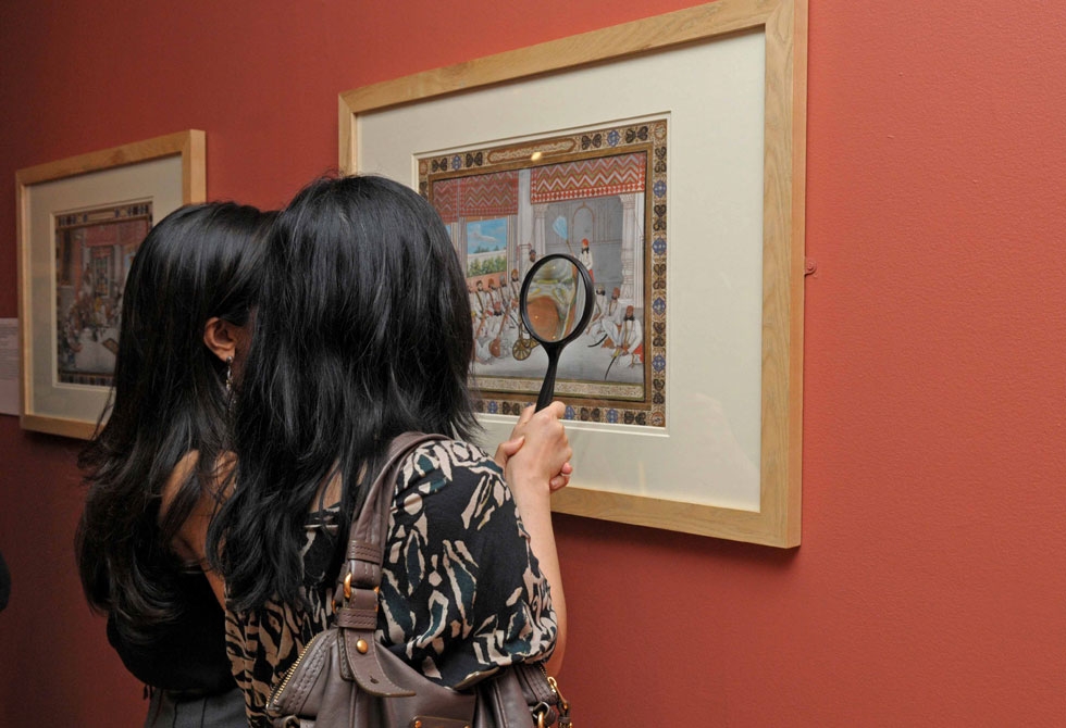 Visitors to Asia Society Museum in New York inspect a piece from the Princes and Painters in Mughal Delhi, 1707 to 1857 exhibition. (Elsa Ruiz/Asia Society)
