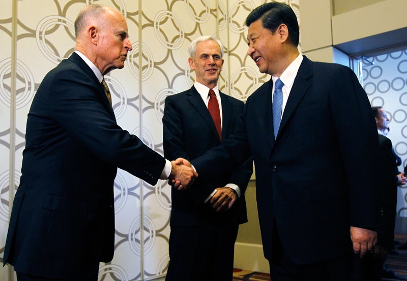 Chinese Vice President Xi Jinping (R) is greeted by CA Governor Jerry Brown (L) as Commerce Secretary John Bryson (C) looks on before speaking at the US-China Economy and Trade Cooperation Forum on Feb. 17, 2012 in Los Angeles. (Pool/Getty Images) 