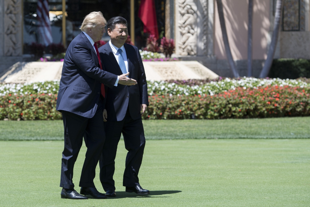 U.S. President Donald Trump and Chinese President Xi Jinping walk together at the Mar-a-Lago estate in West Palm Beach, Florida, April 7, 2017.