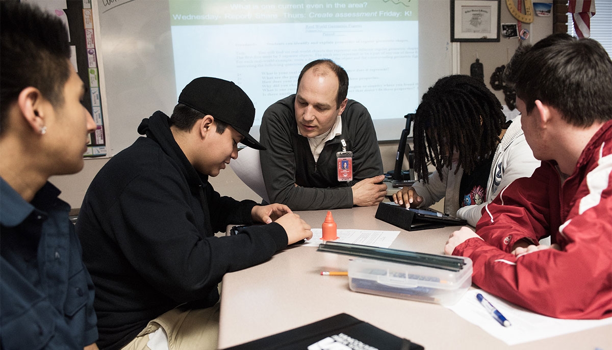 An educator works with a group of students.