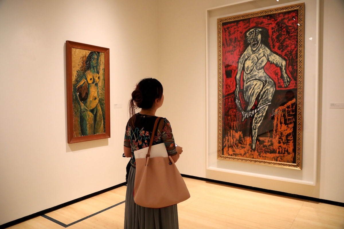 A visitor viewing 'The Progressive Revolution: Modern Art for a New India' at Asia Society New York