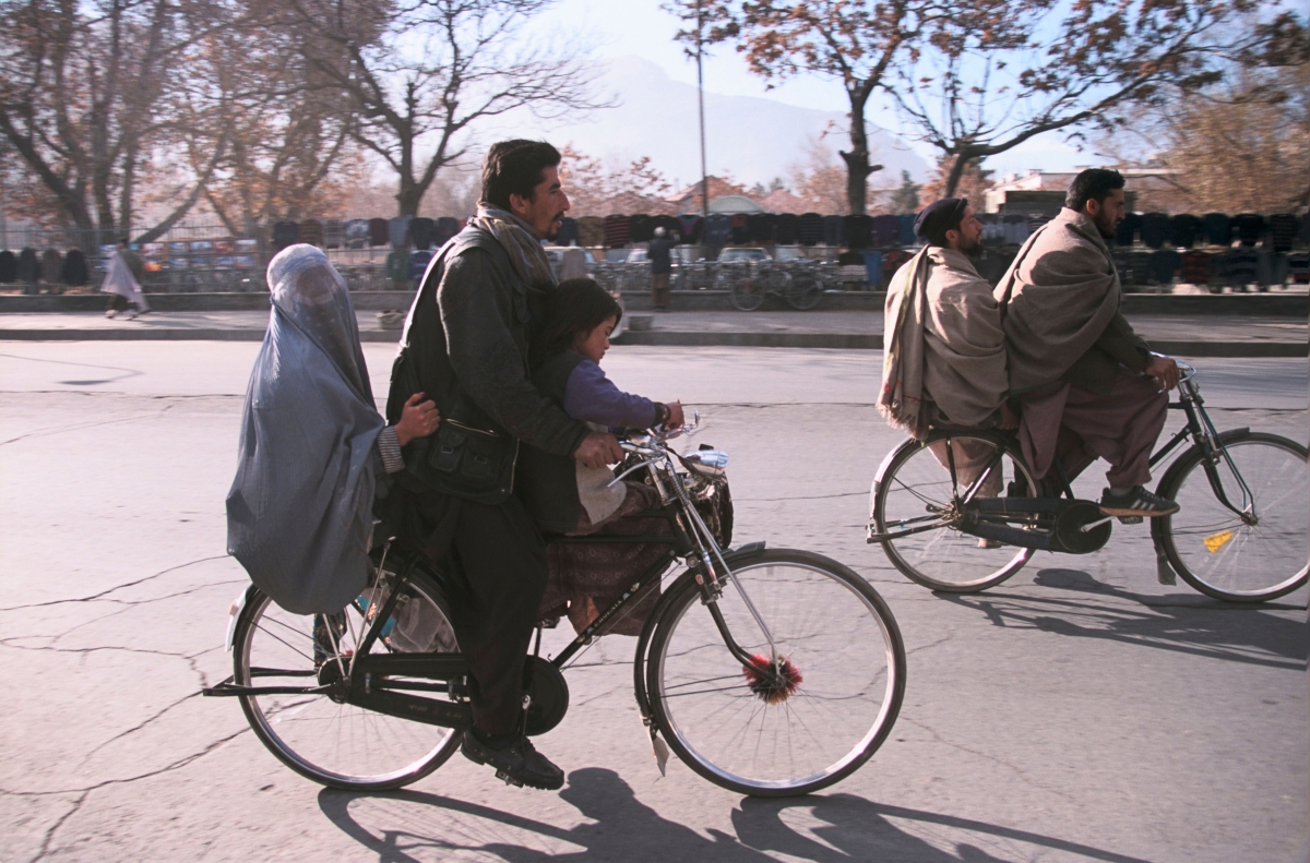 A family rides a bicycle through the street of Kabul in 2003. Nikolai Ignatiev/Alamy
