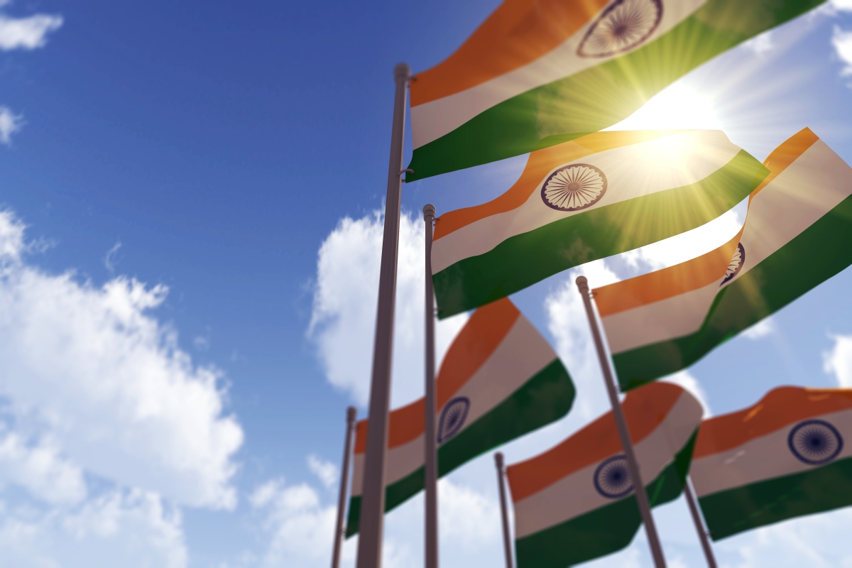 India flags waving in the blue sky - shutterstock - Ink Drop