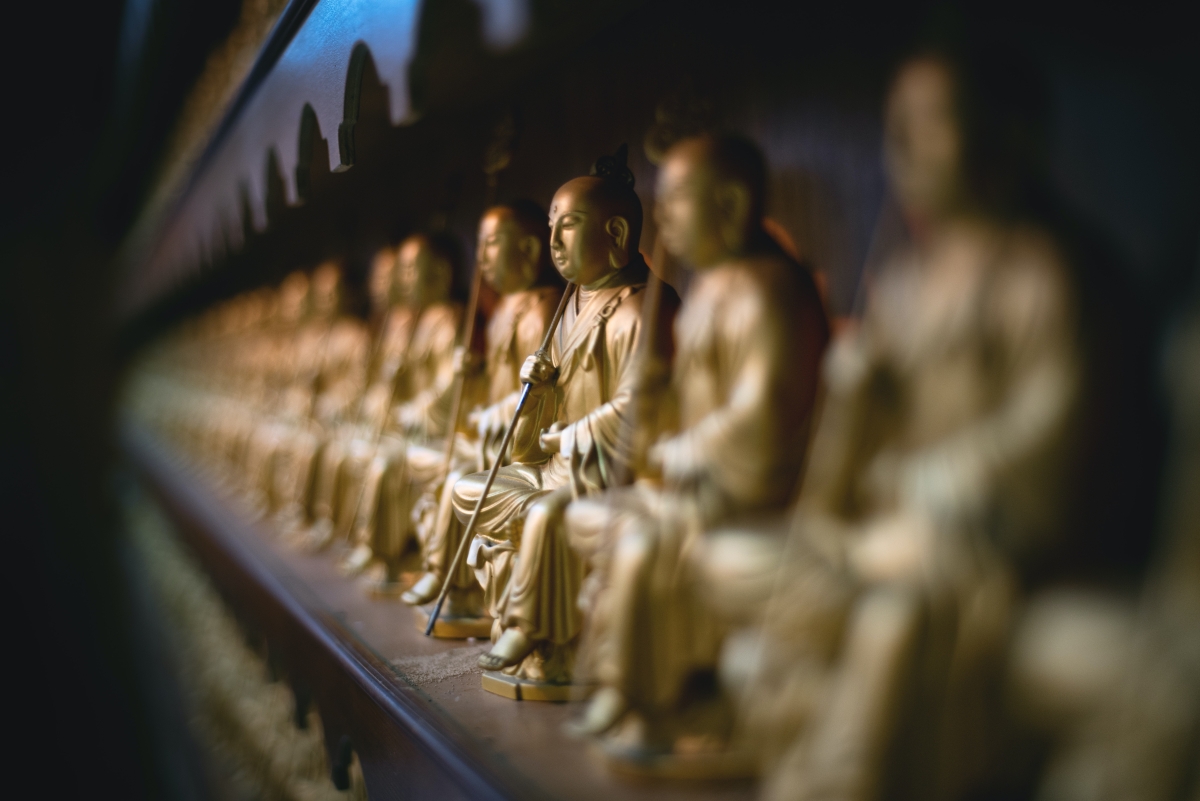 selective focus gold buddha sitting statue on the wall, Fo Guang Shan Chu Un Temple, Cebu City, Philippines