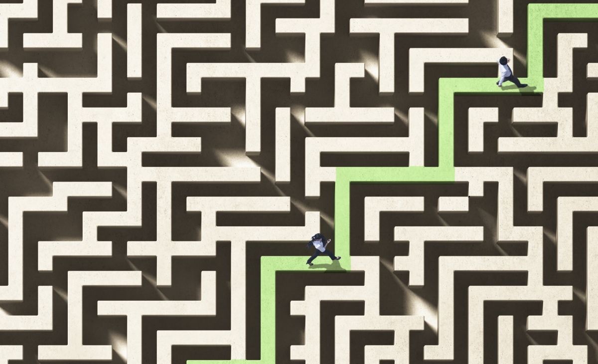 Businesspeople walking through a maze