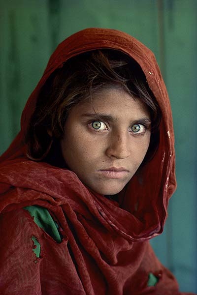 Steve McCurry. Sharbat Gula, "Afghan Girl," at Nasir Bagh refugee camp near Peshawar, Pakistan, 1984. © Steve McCurry.