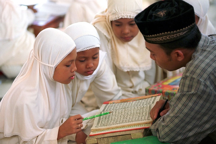 Young girls attend a class where they learn to read and memorize from the Koran in Banda Aceh, Aceh province of Indonesia. (Voja Miladinovic/Getty Images)