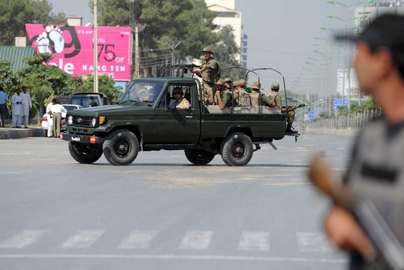 Pakistani soldiers patrol after an attack on the army headquarters in the garrison city Rawalpindi on October 10, 2009. The attack ended with all four suspects killed, according to a military spokesman. (Farooq Naeem/AFP/Getty Images)