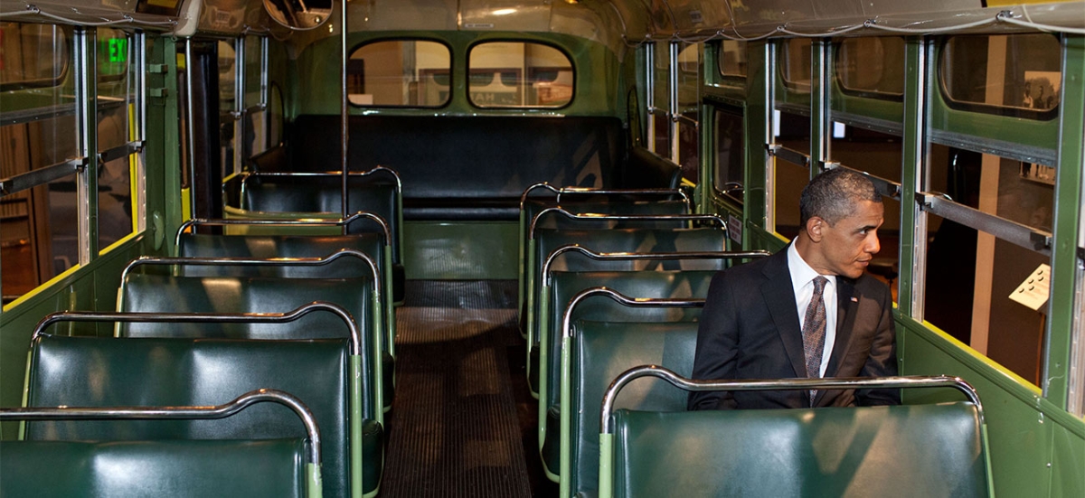 President Obama sits in Rosa Parks' seat on the same bus from her fateful ride.