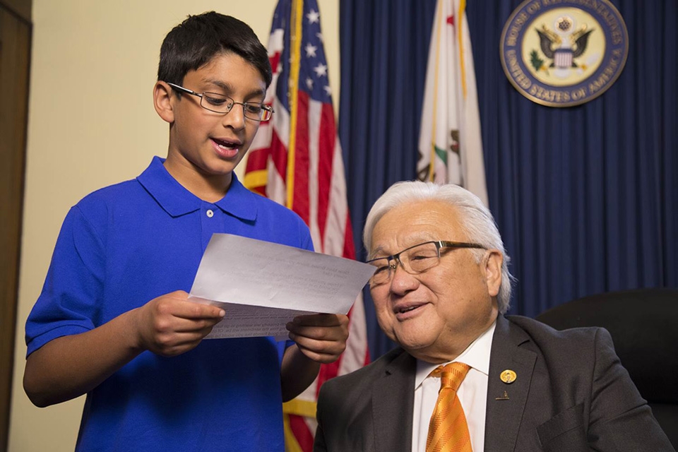 A Muslim American student reads a letter written by a World War II Japanese American internee to U.S. Representative (D-CA) Mike Honda, who was a resident of the Granada War Relocation Center, known as Camp Amache. (Photo courtesy of Frank Chi)