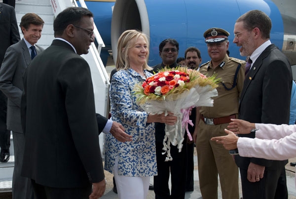 US Secretary of State Hillary Clinton (C) receives flowers after disembarking from her plane upon her arrival in Chennai, India on July 20, 2011. (Saul Loeb/AFP/Getty Images)
