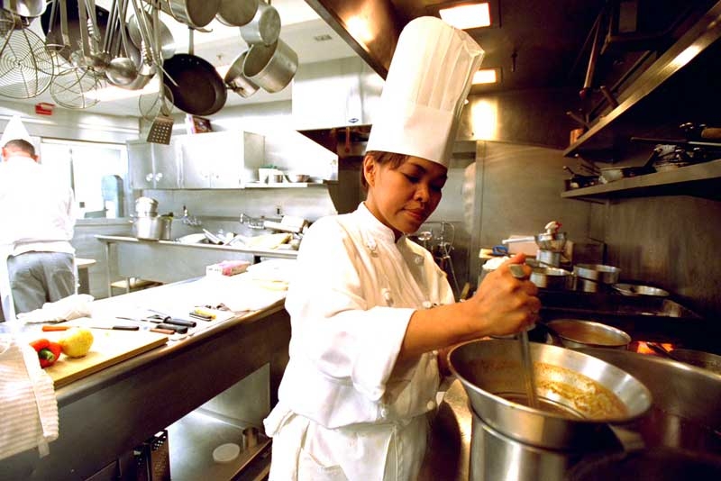 Chef Cristeta 'Cris' Comerford prepares a meal inside the White House kitchen July 17, 2002. In 2005, Comerford was named White House Executive Chef and the first woman to serve in the job. (Tina Hager/White House via Getty Images)