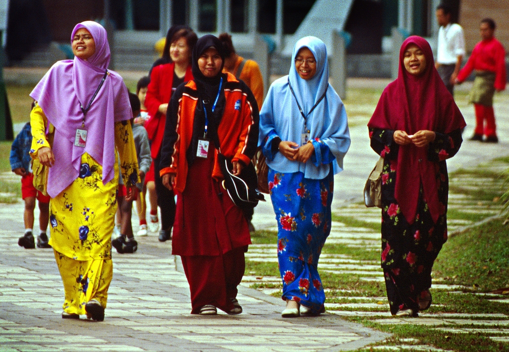 Colorful Islamic Malay women, stolling the park between the Kuala Lumpur Convention Center and the Petronas Towers. (Vin Crosbie/Flickr)
