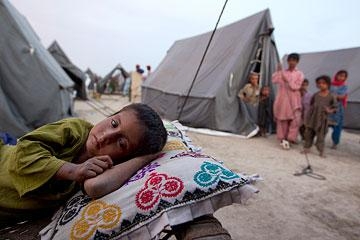 A boy rests at a new camp that opened on Aug. 14, 2010 for flood victims in Sukkur, Pakistan. (Paula Bronstein/Getty Images)