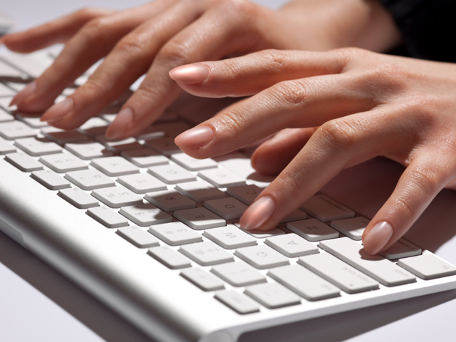 Fingers typing on keyboard. (JamesBrey/iStockPhoto)