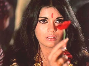 Zeenat Aman holding a red flower