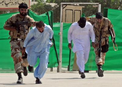 Pakistani paramilitary soldiers capture mock terrorists during an anti-terror drill in Karachi on Sept. 30, 2009. (Rizwan Tabassum/AFP/Getty Images)