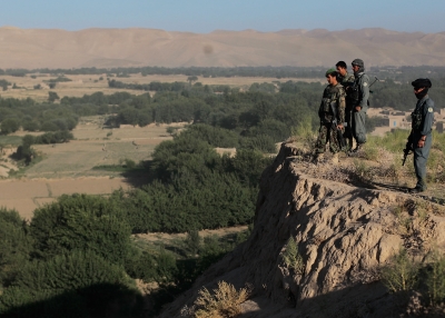 BALA MURGHAB, BADGHIS PROVINCE - JUNE 30: Afghan Army soldiers and National Police members survey a valley from a hill during an early-morning informational mission. (Chris Hondros/Getty Images) 
