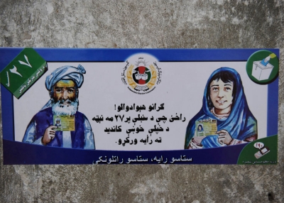 A poster urging Afghans to vote in upcoming elections is stuck to a wall in Kandahar province's Arghandab Valley on August 11, 2010. (Yuri Cortez/AFP/Getty Images) 