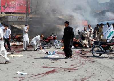 Pakistani Shiite Muslim men help injured blast victims at the site of a suicide bomb attack in Quetta on September 3, 2010. (Banaras Khan/AFP/Getty Images) 