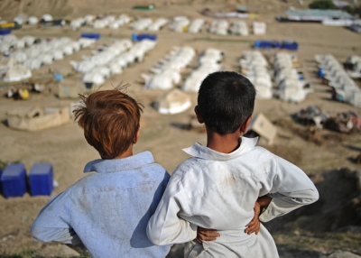 Two boys look out over a large relief camp on September 23, 2010.