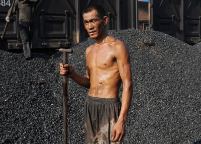 A Chinese miner takes a break as he unloads coal from a train in Hefei, in eastern China's Anhui province on August 4, 2010. (STR/AFP/Getty Images)