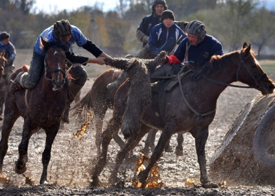 Mounted Kyrgyz men play the traditional Central Asian sport Buzkashi or Kok-boru or Oglak Tartis ('goat grabbing'), in Bishkek on November 4, 2010.