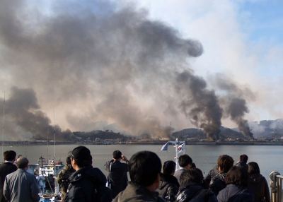 Photo taken by a South Korean tourist shows plumes of smoke rising from Yeonpyeong island in the disputed waters of the Yellow Sea after North Korea fired dozens of artillery shells, Nov 23, 2010., killing two people. (STR/AFP/Getty Images)