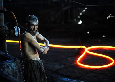 A steel worker is pictured as he washes after working with molten steel at Ittehad Steel Mill Islamabad on November 30, 2010.