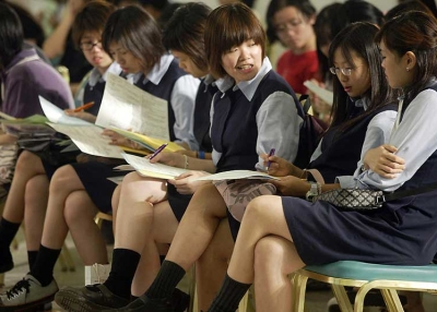 Hong Kong schoolgirls attend a job fair for graduating students. Hong Kong's school system ranked second in the new PISA survey. (Peter Parks/AFP/Getty Images)