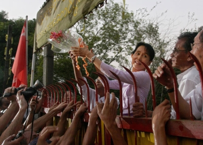 Burma/Myanmar's detained opposition leader Aung San Suu Kyi holds a bouquet of flowers as she appears at the gate of her house after her release in Yangon (Rangoon) on November 13, 2010. The lakeside home had been her prison for most of the past two decades. (Soe Than Win/AFP/Getty Images)