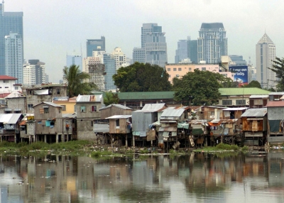This image contrasting Manila's financial district with a squatter colony on the banks of the Pasig River (foreground) suggests some of the challenges facing Asia's cities as the effects of climate change become a reality in the 21st century. (Joel Nito/AFP/Getty Images)