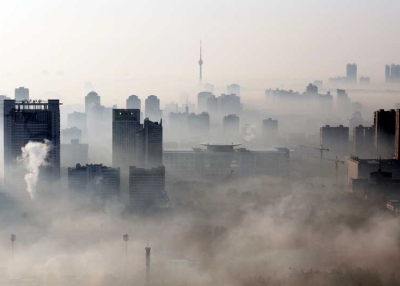 An aerial view of buildings standing out amid haze engulfing Wuhan, central China's Hubei province on Dec. 3, 2009. China will need to invest up to 30 billion dollars a year to meet its goal of curbing greenhouse gas emissions, the state press said, citing an academic study. (STR/AFP/Getty Images)