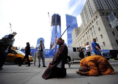 Two Buddhist monks pray in front of Ground Zero and the future One World Trade Center in New York on Sept. 8, 2011. (Emmanuel Dunand/AFP/Getty Images) )