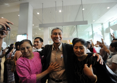 Myanmar academic Aung Naing Oo (C), who fled a brutal crackdown on student protests over two decades ago, is greeted by relatives upon his return to his homeland at Yangon International Airport on February 10, 2012. (Soe Than Win/AFP/Getty Images)
