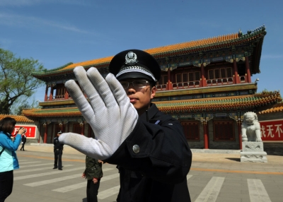 A Chinese policeman blocks photos from being taken outside Zhongnanhai, central headquarters for China's Communist Party, after the sacking of politician Bo Xilai from the country's powerful Politburo, in Beijing on April 11, 2012. (Mark Ralston/AFP/Getty Images)