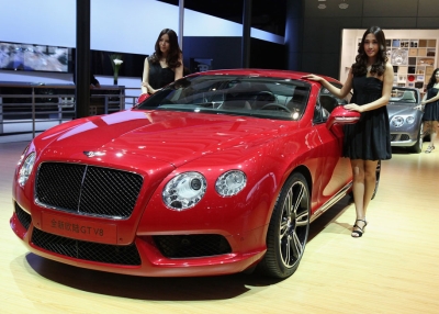 Models stand beside the Bentley Continental GT V8 car during the 2012 Beijing International Automotive Exhibition at China International Exhibition Center on April 25, 2012 in Beijing, China. (Feng Li/Getty Images)