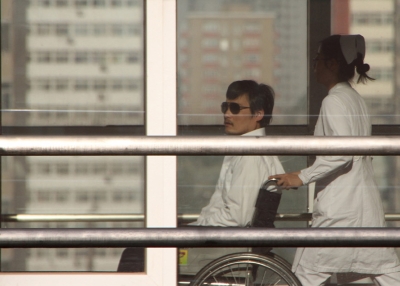 Chinese activist activist Chen Guangcheng (L) is seen in a wheelchair pushed by a nurse at the Chaoyang hospital in Beijing on May 2, 2012. (Jordan Pouille/AFP/GettyImages)