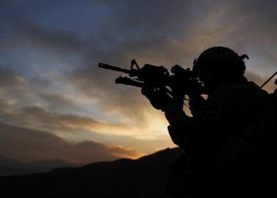 A soldier with Troop B, 1st Squadron, 113th Cavalry Regiment, Task Force Redhorse scans a nearby hilltop during a search of the Qual-e Jala village, Afghanistan. (The U.S. Army/Flickr)