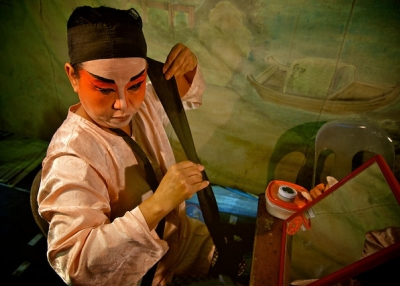 A Teochew Street Opera Troupe performer wraps her head on September 1, 2012 at Pulau Ubin. (calvinistguy/Flickr)