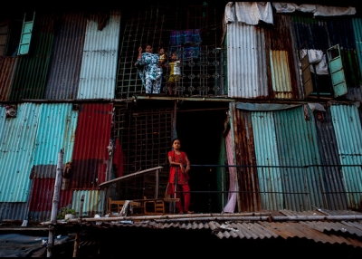 Residents of a slum apartment complex stand watchful in Dhaka, Bangladesh on August 25, 2012. (Zoriah/Flickr)