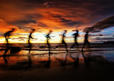 A man runs down the beach in the golden glow of the sun in Labuan, Malaysia on April 13, 2012. (SaturatedEyes/Flickr)