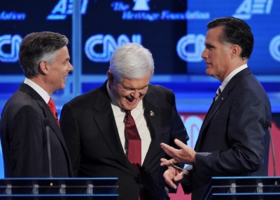Jon Huntsman (L) confers with Mitt Romney (R) and Newt Gingrich (C) prior to the start of the Republican presidential debate on national security on Nov. 22, 2011 in Washington, DC. (Mandel Ngan/AFP/Getty Images)