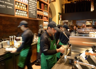 Staff work behind the counter of India's first newly-inaugurated Starbucks outlet in an upscale part of Mumbai on October 19, 2012. (Punit Paranjpe/AFP/Getty Images)